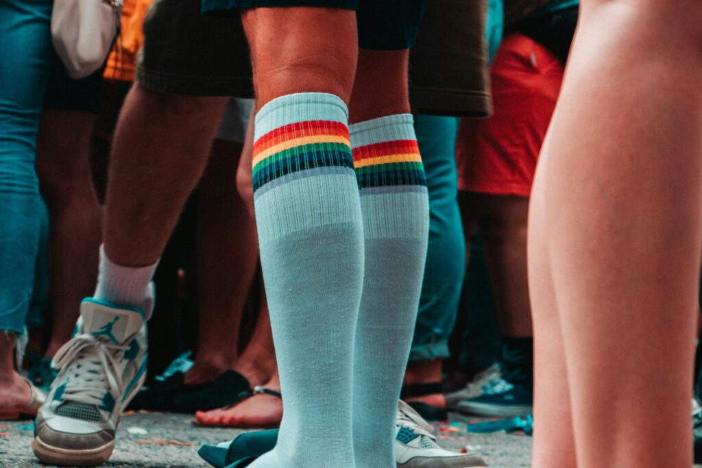 rainbow colored compression socks on male legs
