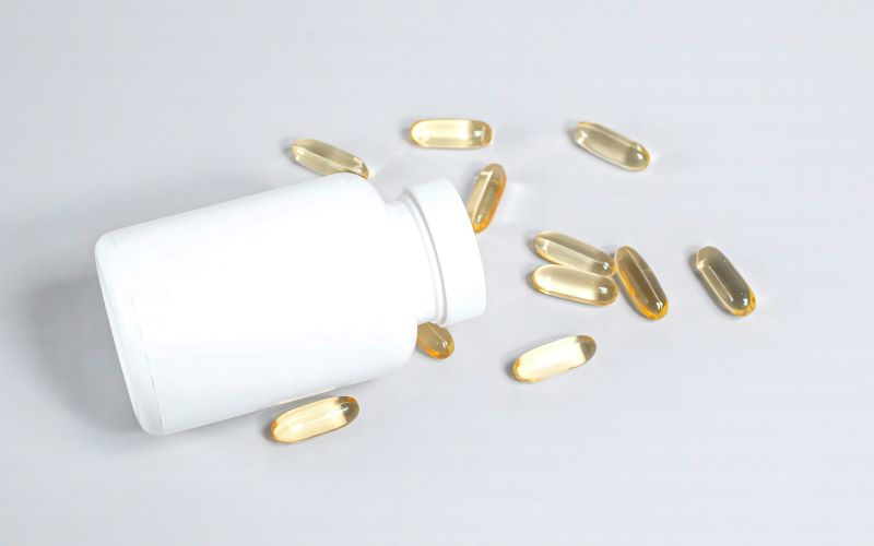 A bottle surrounded by fish oil supplements